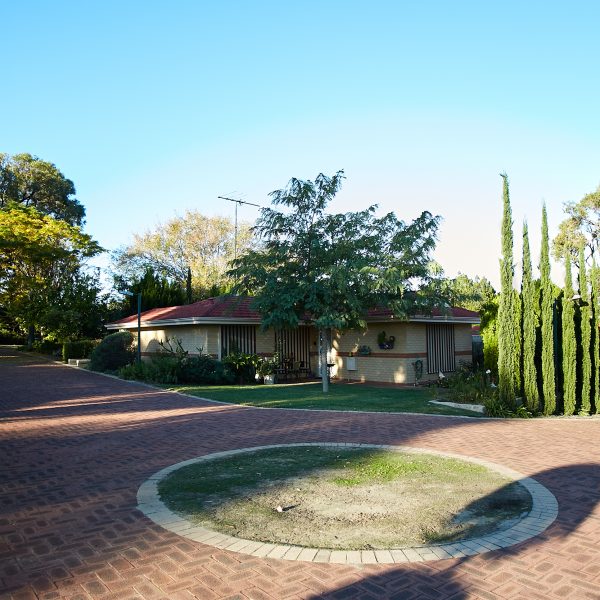 Roundabout at Edgewater Mercy Place Retirement Village showing home and green trees
