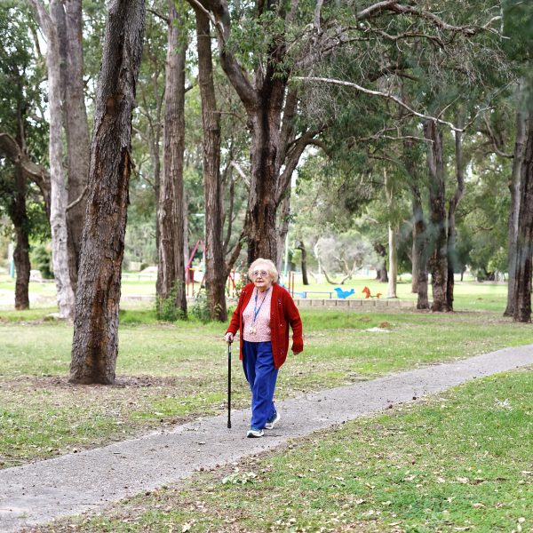 Resident of Villa Maria with her walking stick, enjoying a walk in the park
