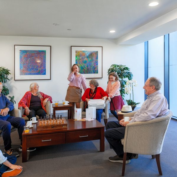 Residents gathered in the community lounge playing games at Mercy Place Parkville