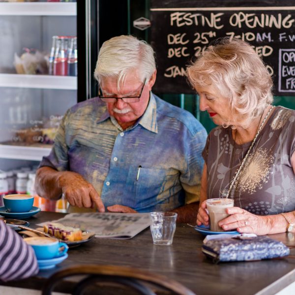 Two residents looking at the menu in a café