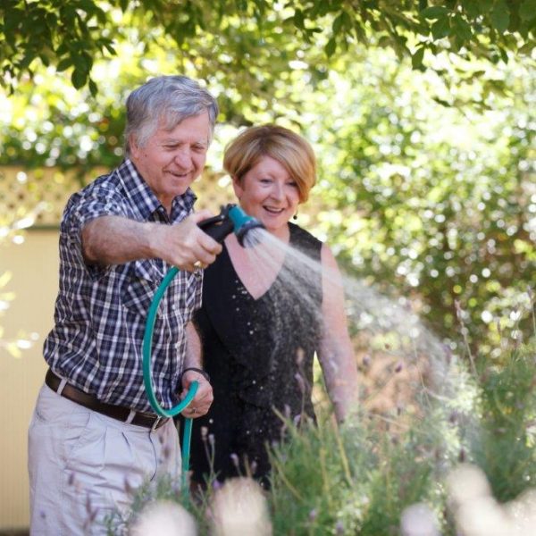 Residents at Golden Rise hosing the green plants