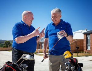 Two gentlemen with golf clubs talking at Golden Rise retirement Bendigo
