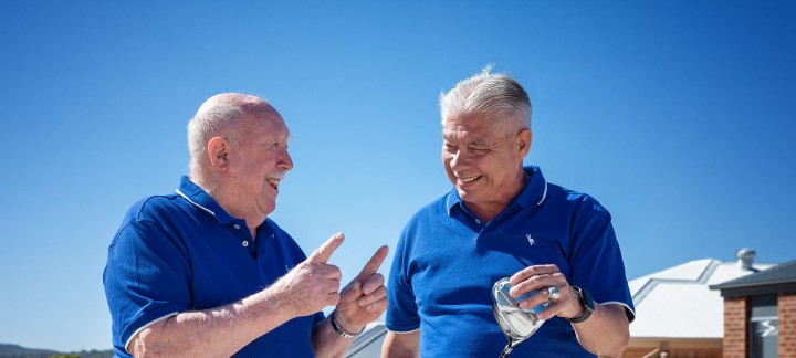 Two gentlemen with golf clubs talking at Golden Rise retirement Bendigo