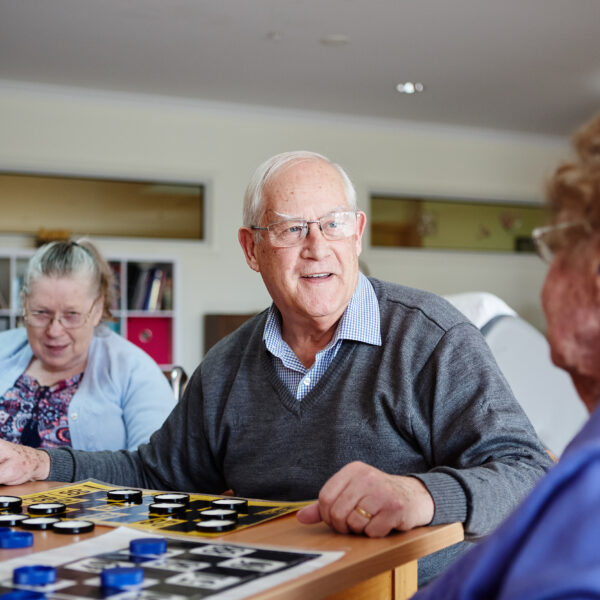 Residents enjoying a board game at Mercy Place Colac