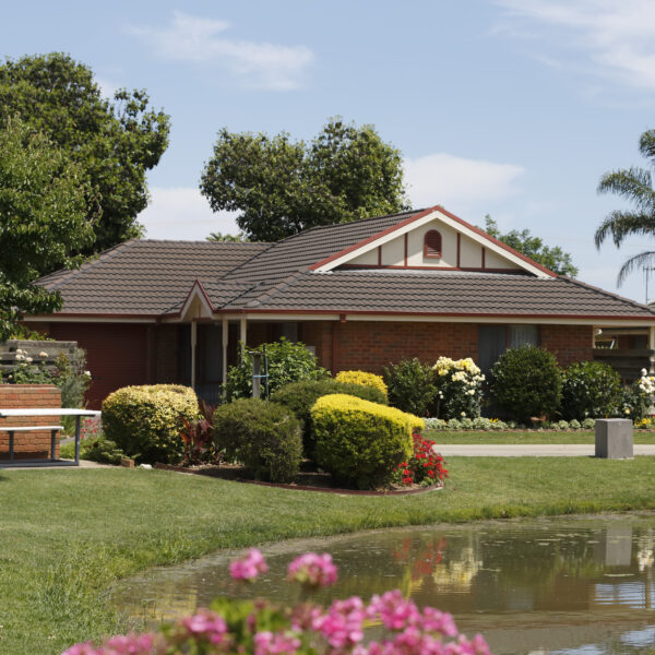Exterior of Shepparton Independent Living Unit with manicured gardens and lake